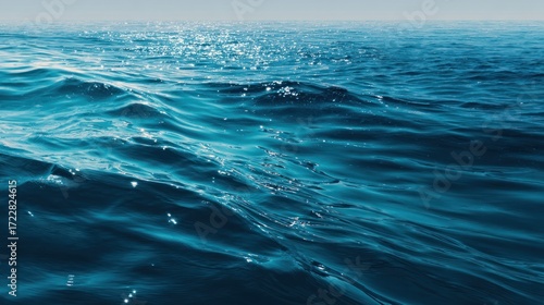 Serene Blue Ocean Waves under Bright Sunlight on Calm Surface
