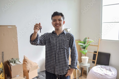 Smiling Male Holding Keys from His New House. Relocate or Rental Concept.