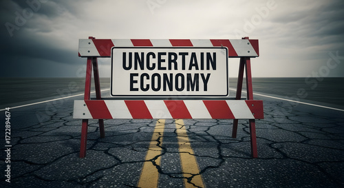 Roadblock Sign Warning of Uncertain Economy on Cracked Asphalt Road