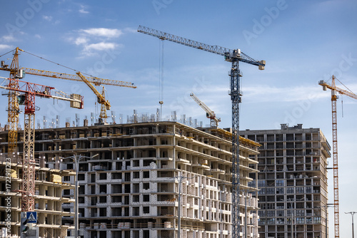 Tower Crane on building construction. Construction crane on Housing. Construction site, Multi Storey Residential Buildings construction. Formworks. Modern Townhome building. Modern House building.