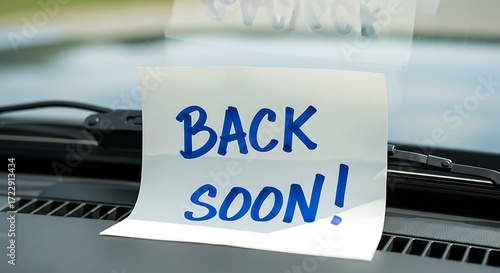 Car dashboard sign displaying 'back soon' message expressing temporary absence