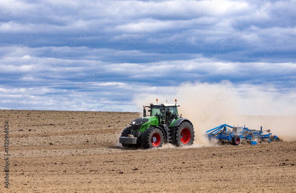 Obraz premium Agricultural plows are plowed to wait for the farming season. Farmer with tractor seeding.