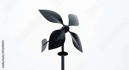 Minimalist leaf-shaped metal wind spinner sculpture against a stark white backdrop outdoors