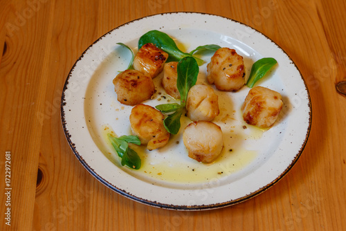 Delicious fried scallops on a table