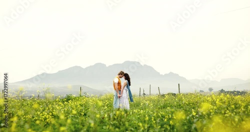 Wallpaper Mural Couple, kiss and meeting on field, flowers and happy with sky, space and love in countryside in spring. Woman, man and walk in nature with holding hands, care and relationship with vacation in Greece Torontodigital.ca