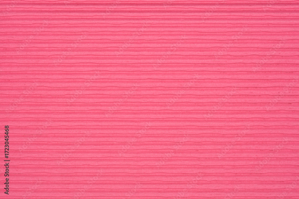 Fototapeta premium A full-frame, detailed close-up of a pink textured cardboard surface with fine horizontal lines