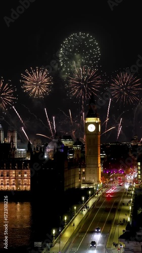 Elevated view of the Big Ben clocktower and Westminster Bridge in London, England, during night time with fireworks for new years