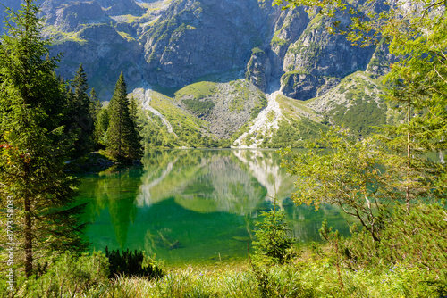 landscape with lake in mountains. scenic nature of poland with rocky peaks in summer. high tatras are wonderful place for travel in eastern europe