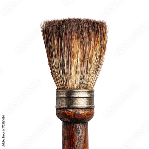 Close-up of a weathered paintbrush head and wooden handle