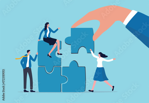 Build your team, leadership to develop teamwork or business partner, cooperate or collaborate for success, assist or help, giant businessman hand connect last jigsaw puzzle to office business team
