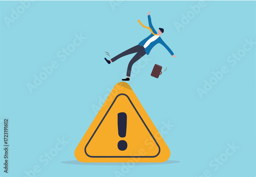 Mistake caution, business risk or problem warning, failure prevention or avoid danger concept, cautious businessman slip falling on exclamation symbol beware, careful caution sign.	
