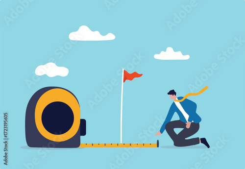 Business success measurement, how far from business goal and achievement or growth metric analysis concept, smart businessman using measuring tape to measure and analyze distance from target flag.