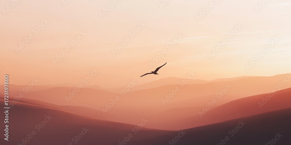 Naklejka premium Bird flying over a mountain range with a pink sky in the background