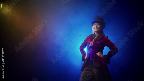 Happy young woman taking off top hat making respectful bow curtsy gesture greeting. Girl smiling face wearing bowler hat. red tailcoat frock coat suit. 18th 19th century vintage old style blue night