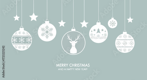 Elegant white Christmas ornaments with snowflakes and reindeer hang against a serene muted blue background, perfect for festive greetings.