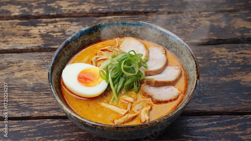A warm, hearty bowl of soup featuring bacon, egg, and vegetables served in a savory broth.