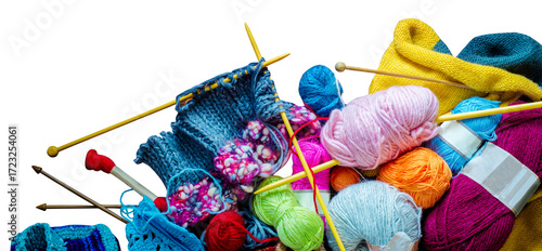 Lots of balls of wool, knitting needles and other tools.  