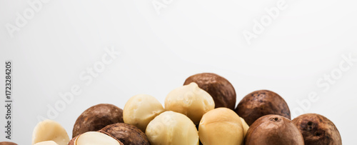 Still life of shelled and unshelled healthy macadamia nuts.