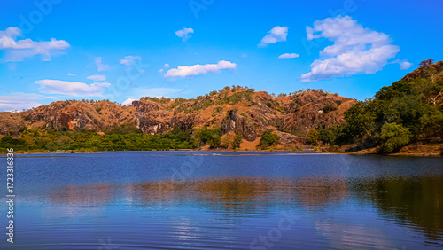 a calm lake surrounded by hills