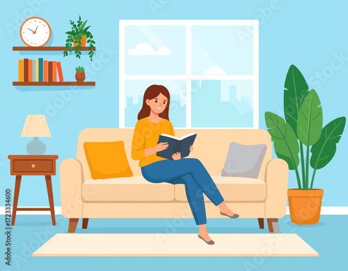 A woman sits comfortably on a beige couch in a living room, engrossed in reading a book, with a window and plant in the background.