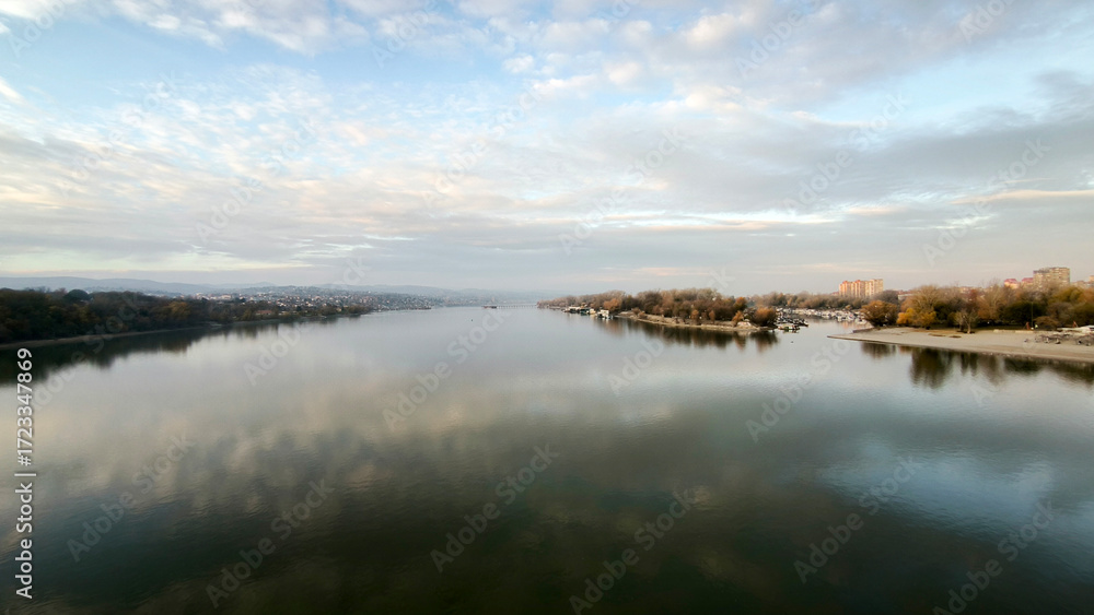 Fototapeta premium landscape by the Danube river in Novi Sad in autumn, with clouds reflected in the water