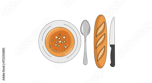 A hearty bowl of pumpkin soup served with a fresh baguette and cutlery for a delicious meal.