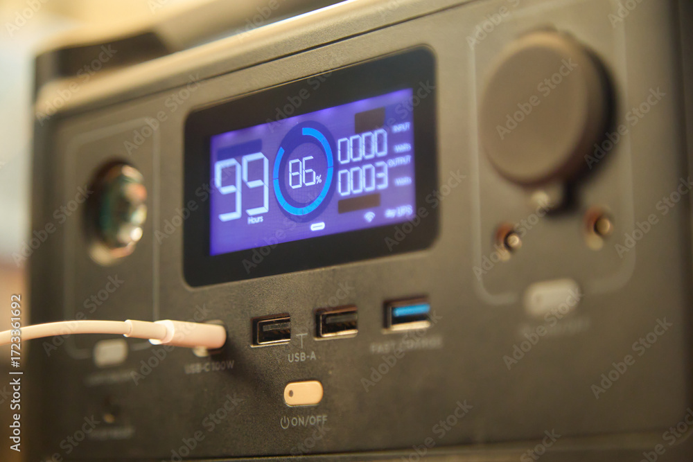 Fototapeta premium Portable power station charging a phone close-up. Backup energy