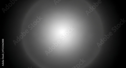 Abstract grayscale image with a central bright circular light