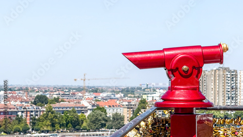 Slika na platnu Red telescope gazing over urban sprawl, invoking World Photography Day, urban ob