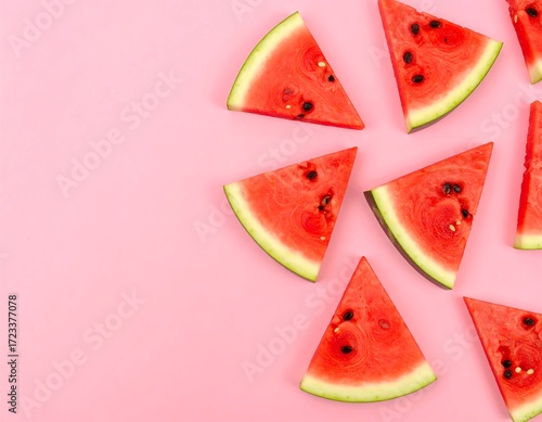 Watermelon slices arranged on pink background