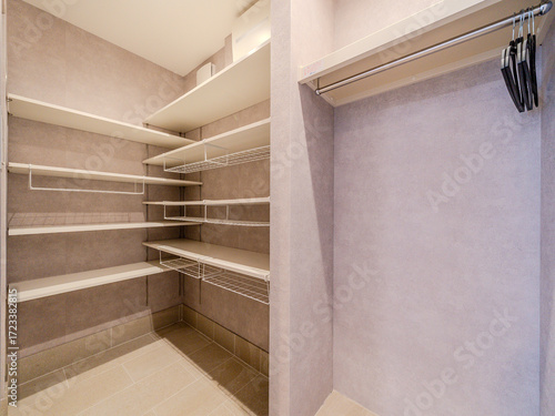 Storage room with adjustable shelves and hanging rail