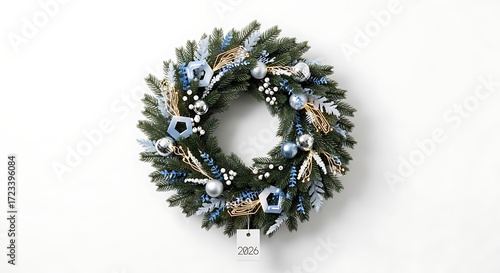 Festive holiday wreath adorned with silver ornaments and blue accents on a white background