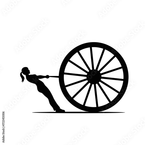 Silhouette of a woman pulling a large wagon wheel