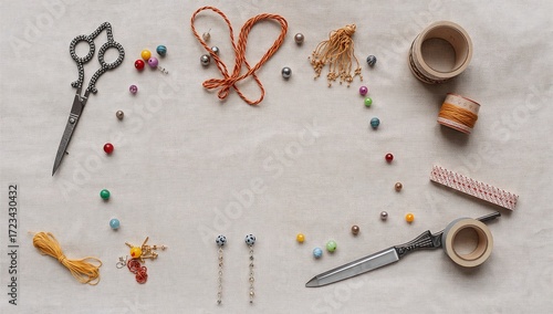 Sewing tools and accessories on a wooden table, top view. Sewing accessories, threads, buttons, needles and fabric on the table