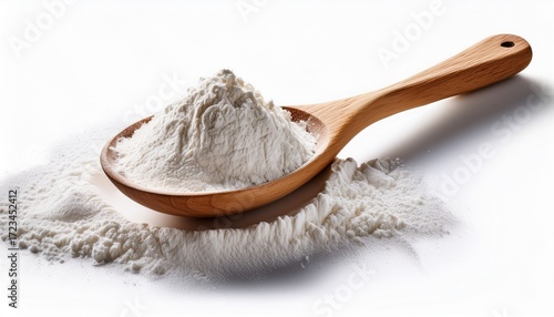 wooden spoon filled with white flour and spilled powder isolated on white background