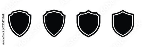 Four different black shield icons isolated on white background