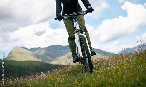 Riding mountain bike on grassland mountain top