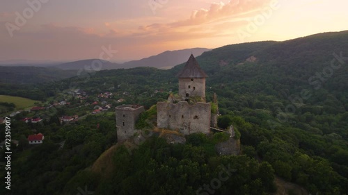 Beautiful gothic castle in Slovakia at Sunset. Šomoška, medieval castle. Drone footage.