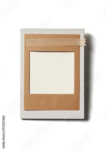 A light grey square background holds a beige photo frame with a blank white space inside, secured with a piece of tan tape at the top
