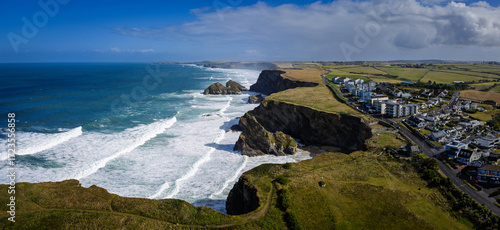 Surf and waves Mawgan Porth north Cornwall England near Newquay and south of Porthcothan and Treyarnon on a summer day with blue sk