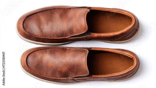 Pair of brown leather slip-on shoes.  Top-down view, showing the soles and uppers.  The shoes are a light reddish-brown