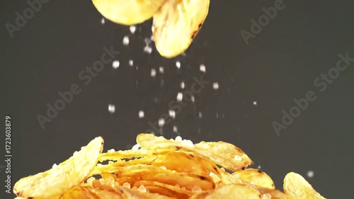 Salty chips are playfully sprinkled with salt, creating a tempting and delicious snack scene.