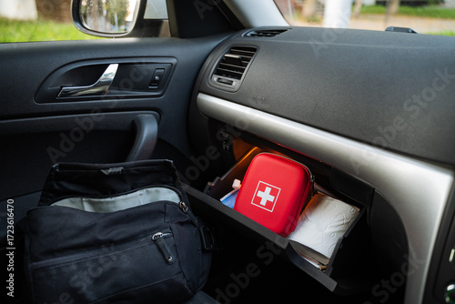 The organized interior of your car includes a first aid kit and other essential items conveniently stored in the glove compartment for easy access during emergencies or road trips