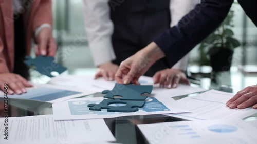Wallpaper Mural A group of people are working on a puzzle together Torontodigital.ca