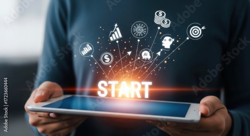 Person holding tablet with startup icons and start text