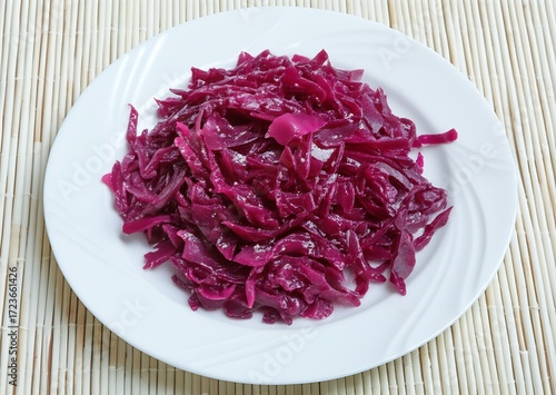 Braised sweet and sour rotkohl, a vibrant dish of red cabbage, perfectly complements roasted meats, offering a delightful culinary pairing.