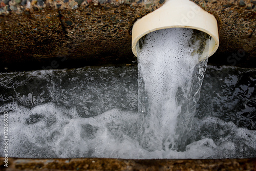 фотографія Wastewater Discharge from Industrial Drain Pipe into Sewer System