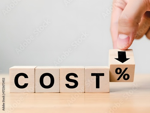 Wooden Blocks Spelling COST with Hand Adjusting Downward Arrow and Percent Sign