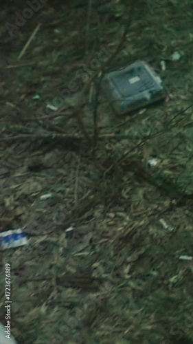 Wallpaper Mural A blurred view of a man in a green jacket smoking, with smoke visibly coming out of his nose and mouth, the foreground shows litter on the ground Torontodigital.ca