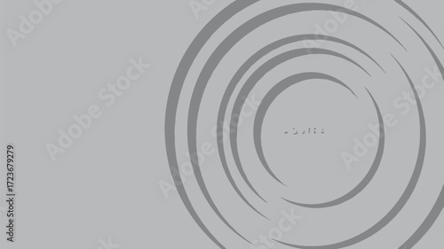 Abstract gray background with concentric, irregular dark gray rings creating a ripple or target effect on the right side, featuring a subtle central detail.